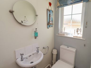 A bathroom with a sink and toilet at Marie's Cottage in Craster