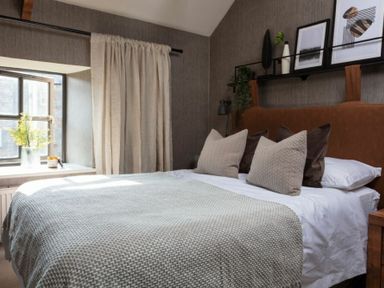 A bedroom with a bed pillows blanket window with curtain and framed pictures on the wall at Lantern View in Eglingham