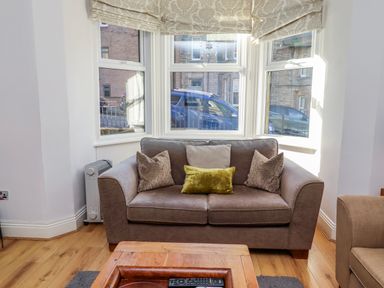 A living room with a sofa and coffee table at Alnbank in Alnmouth