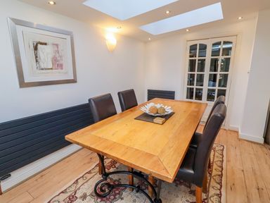 A dining room with a wooden table and chairs at Alnbank in Alnmouth