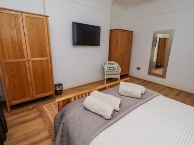 A bedroom with a bed and wardrobe at Alnbank in Alnmouth