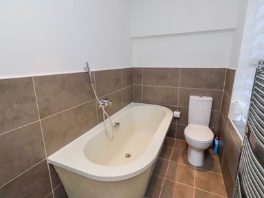 A bathroom with a bathtub and toilet at Alnbank in Alnmouth