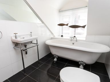 A bathroom with a clawfoot bathtub sink and toilet at Upper Alnbank in Alnmouth