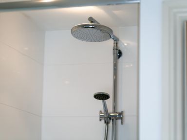 A shower area with two shower heads in a bathroom at Upper Alnbank in Alnmouth