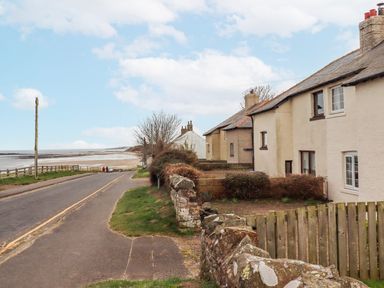A street view with houses and a road at St Marys Cottages No4 Low Newton-by-the-Sea