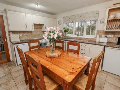 A kitchen with a table and chairs at St Marys Cottages No4 Low Newton-by-the-Sea