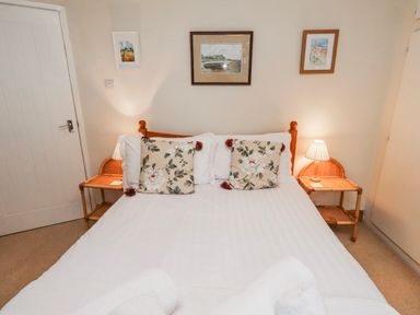 A bedroom with a bed and side tables at St Marys Cottages No4 Low Newton-by-the-Sea