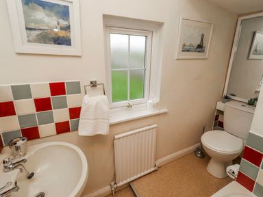 A bathroom featuring a sink and toilet at St Marys Cottages No4 in Low Newton-by-the-Sea