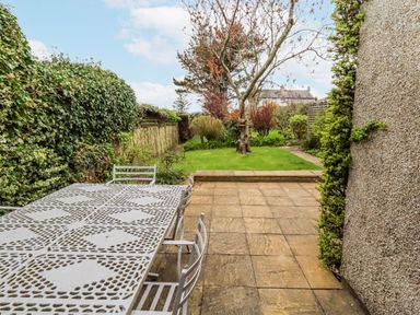 A garden with a table and chairs at St Marys Cottages No4 in Low Newton-by-the-Sea