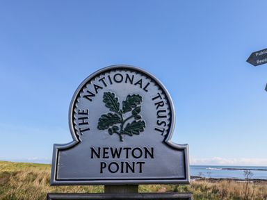 A sign for The National Trust at Newton Point in Low Newton-by-the-Sea