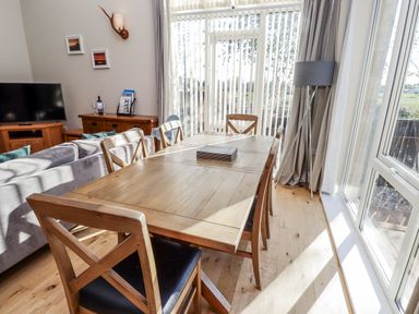 A dining room with a table and chairs at Red Fox in Lucker