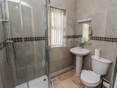 A bathroom with a shower, sink and toilet at Red Fox in Lucker