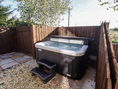 An outdoor area with a hot tub and steps at Red Fox in Lucker