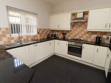 A kitchen with cabinets and appliances at Roe Deer in Lucker