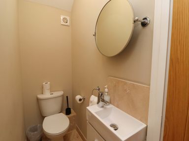 A bathroom with a toilet and sink at Roe Deer in Lucker