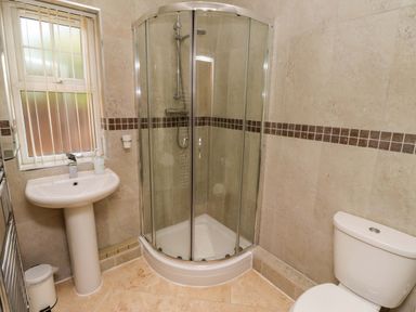 A bathroom with a shower, sink, and toilet at Roe Deer in Lucker