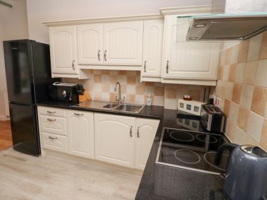 A kitchen with cabinets, sink, and appliances at Chiff Chaff in Lucker