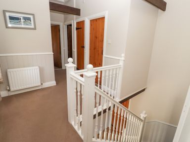 A staircase and doors in a hallway at Bullfinch in Lucker