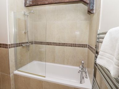 A bathroom with a bathtub and shower at Bullfinch in Lucker