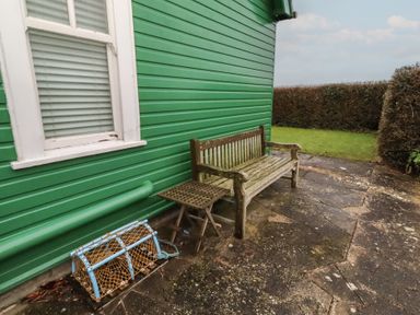 A bench and a lobster trap in an outdoor area at Armstrong Cottages No6 Bamburgh