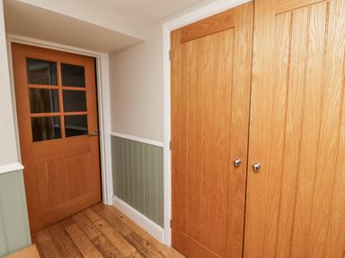 A hallway with wooden doors and a closet at Old Mill (Lucker)