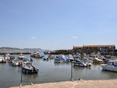 Harbor with boats docked near buildings and hills in the background at The Penthouse @ No 5 in Lyme Regis