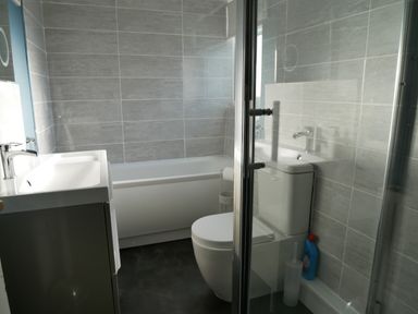A bathroom with a bathtub a toilet a sink and a shower enclosure at Pebble Reef in Easton Portland