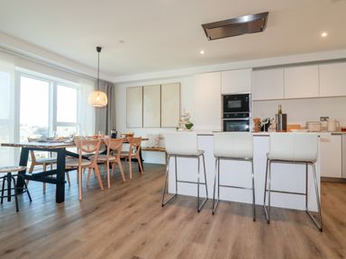A kitchen and dining area with high stools at 33 Cliff Edge in Newquay