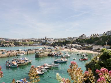 A harbor with boats docked in the water and buildings on cliffs at 33 Cliff Edge in Newquay