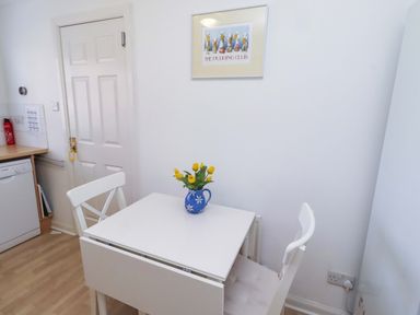 A kitchen with a table and chairs at 6 Westview in Embleton