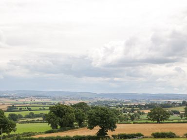 A rural landscape with fields trees and distant hills at Palace Farmhouse in St Weonards