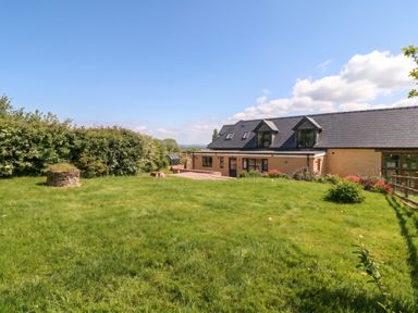 An outdoor space with a house and garden at Palace Farmhouse St Weonards