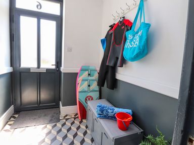 A hallway with a wetsuit and beach gear at Ty Haul in Rhosneigr