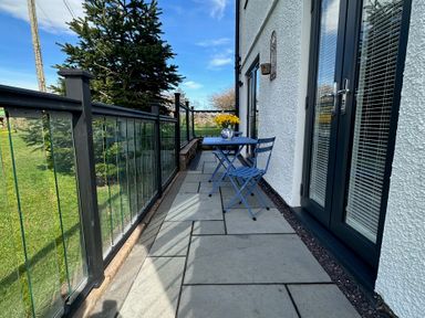 An outdoor area with a table and chairs at How Hill Farm Cottage in Greystoke
