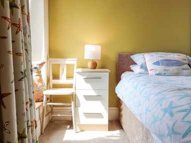 A bedroom with a bed and bedside table at Bryn Mor in Benllech