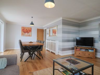 A dining room with a table and chairs at Rainbow View in Churchstanton near Churchinford