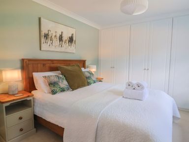 A bedroom with a bed and nightstand at Rainbow View Churchstanton near Churchinford