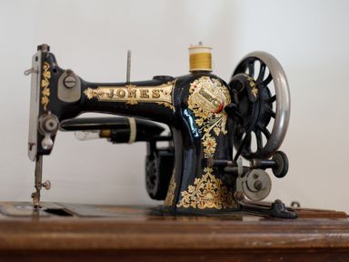 A vintage black and gold sewing machine on a wooden table at Aarons Cottage in St Teath