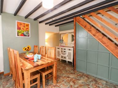 A dining room with a table and chairs at 11- 13 High Street