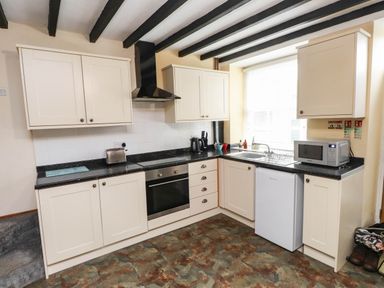 A kitchen with cabinets, oven, sink, and appliances at 11- 13 High Street