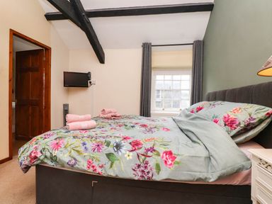 A bedroom with a bed and television at 11- 13 High Street