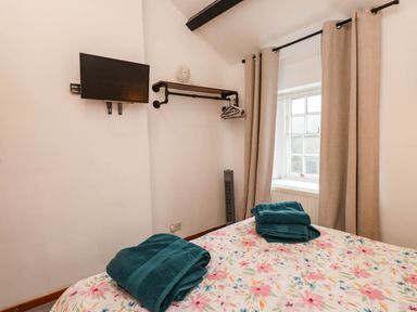 A bedroom with a bed and television at 11- 13 High Street