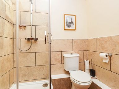 A bathroom with a shower and toilet at 11- 13 High Street