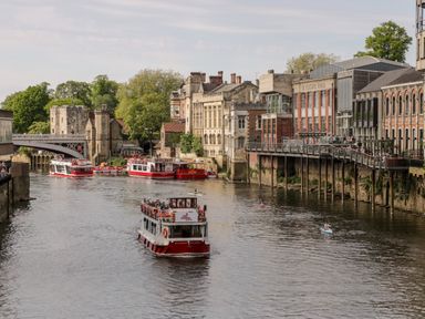 A river with boats and buildings along the banks at 6 Granary Court in York