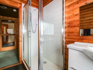 A bathroom with a glass shower enclosure and a white sink cabinet at Rocksite in Kirkmichael Perth And Kinross