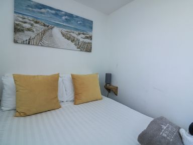 A bedroom with a bed and pillows at Sunset Sea View Chalet Millbrook