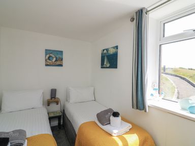 A bedroom with two single beds at Sunset Sea View Chalet in Millbrook