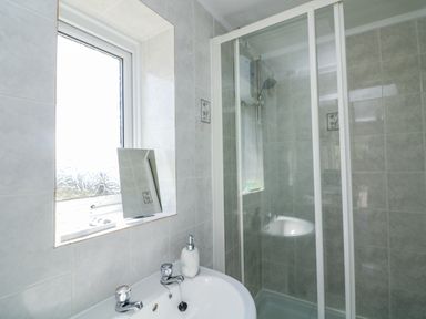 A bathroom with a sink and shower at Sunset Sea View Chalet in Millbrook