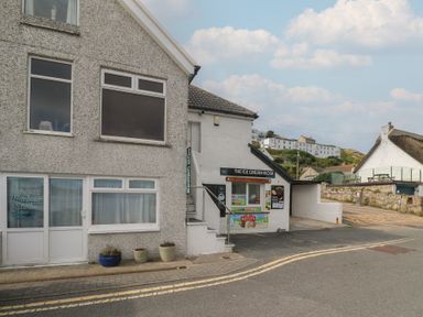 An outdoor view of an ice cream kiosk at Harbour Studio in Sennen Cove
