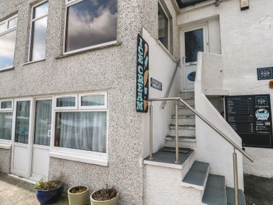 An outdoor area with stairs and an ice cream sign at Harbour Studio in Sennen Cove